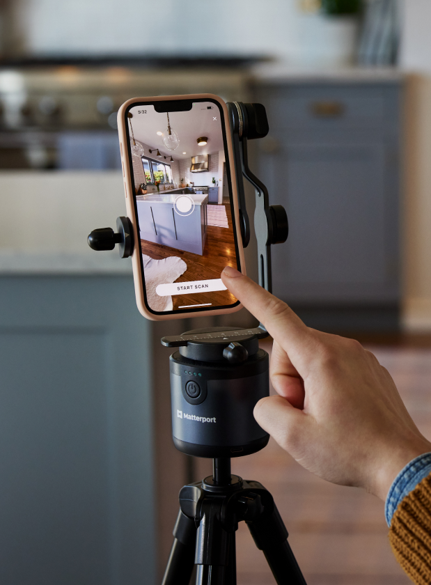 Image of a smartphone showing a Matterport scan, mounted on a tripod