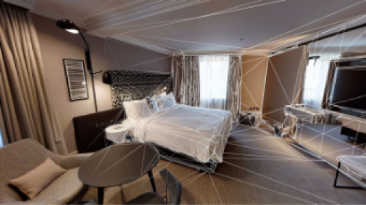 Image of a hotel room with matterport lines superimposed on top